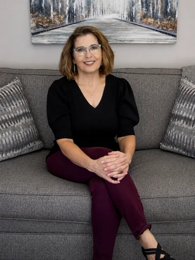 Rachele Epp, LMHC on a gray couch